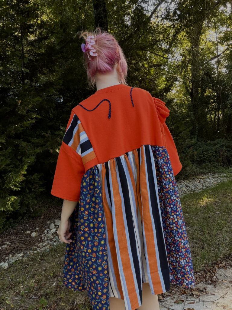 the back of an orange patchwork dress
